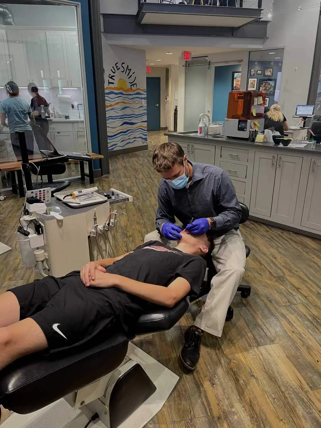 Team member examining patient's teeth