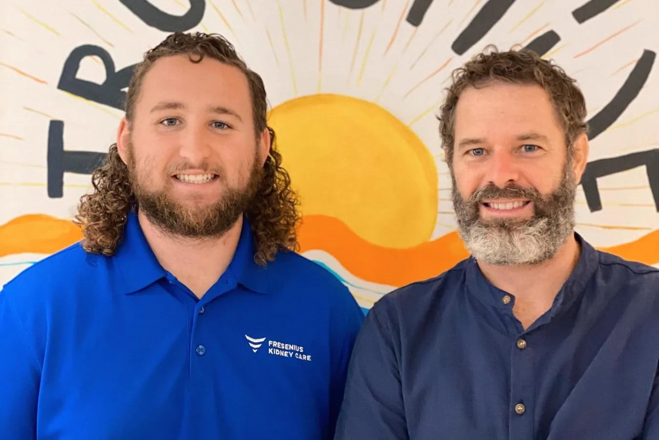 SureSmile Aligners promotion featuring two smiling men in front of a colorful backdrop, emphasizing discreet teeth straightening solutions by True Smile Orthodontics.
