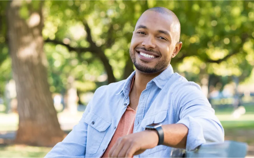 Man sitting on a bench smiling